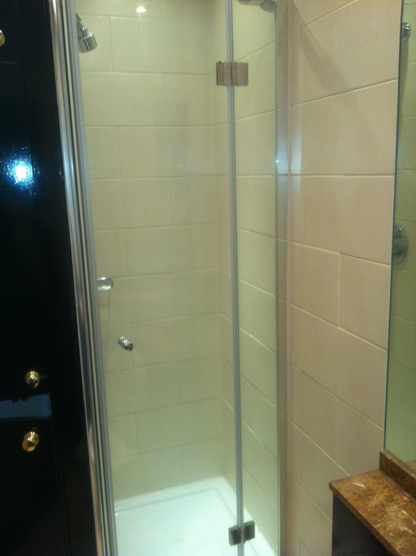 Frameless glass shower enclosure with chrome fittings in Borehamwood