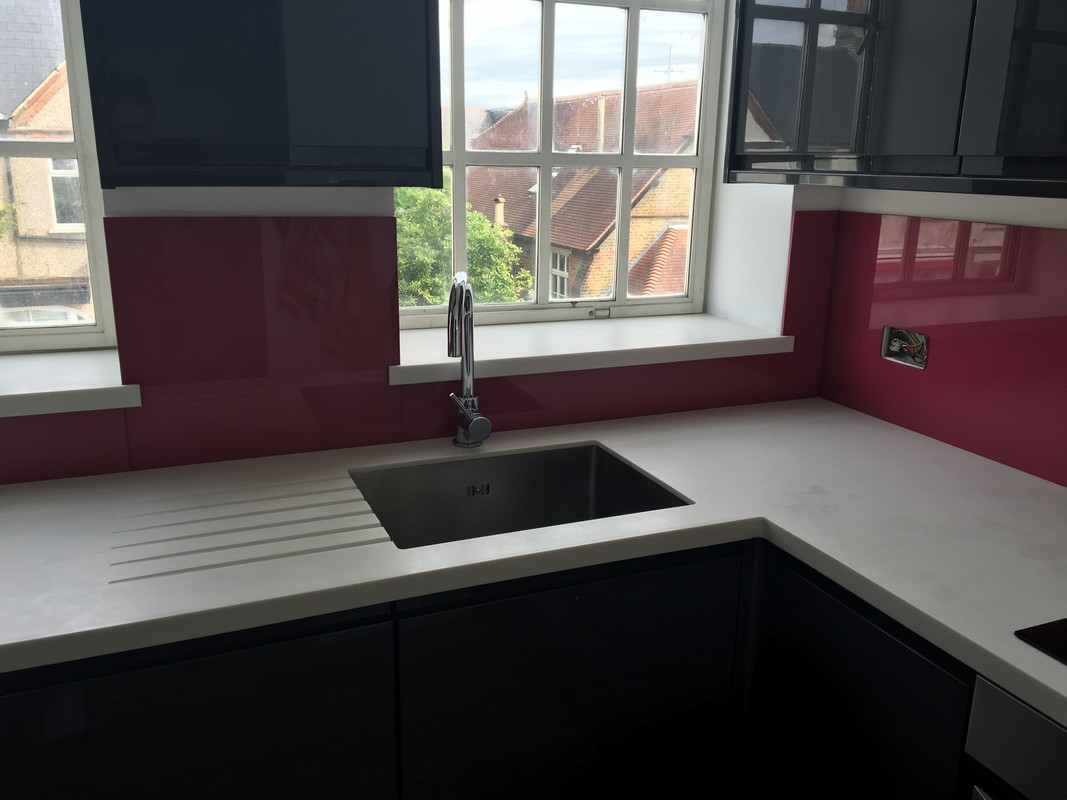Deep plum coloured glass splashback in modern Borehamwood kitchen